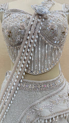 Ivory Pearl Embellished Fish Cut Designer Lehenga Set with Sculpted Corset Blouse & Dramatic Draped Trail