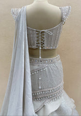 Ivory Pearl Embellished Fish Cut Designer Lehenga Set with Sculpted Corset Blouse & Dramatic Draped Trail