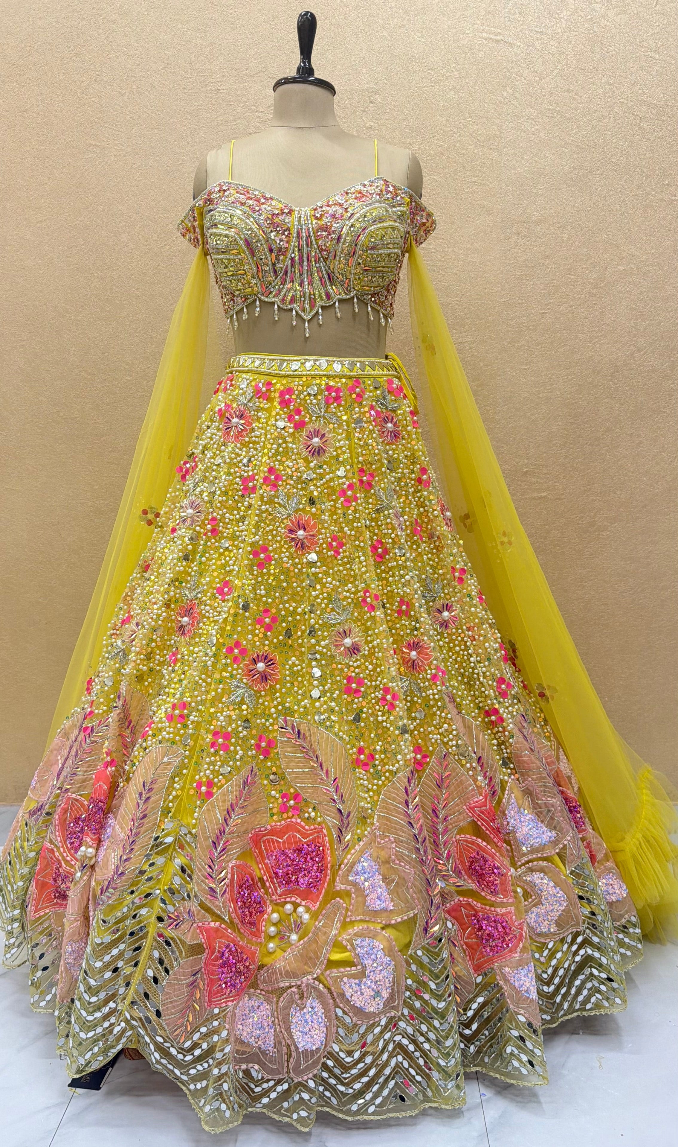 Luxury yellow designer lehenga with heavy mirror work, pearl embroidery, floral sequins, embellished corset blouse and couture bridal craftsmanship