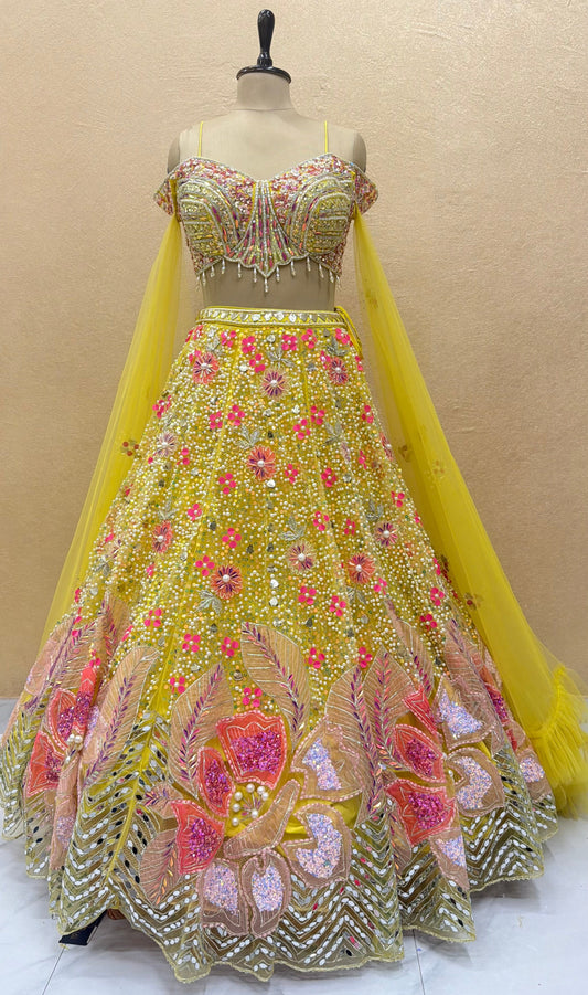 Luxury yellow designer lehenga with heavy mirror work, pearl embroidery, floral sequins, embellished corset blouse and couture bridal craftsmanship